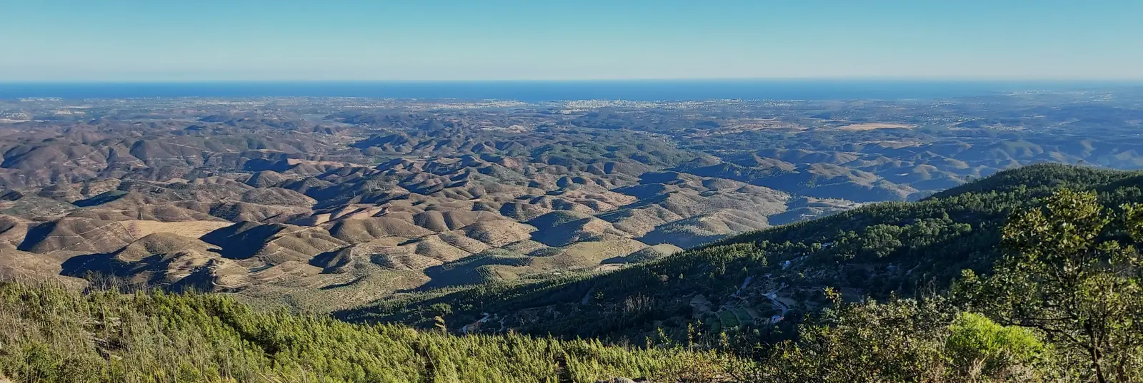 Panorama from the Silves hills over rolling ridges to the coast